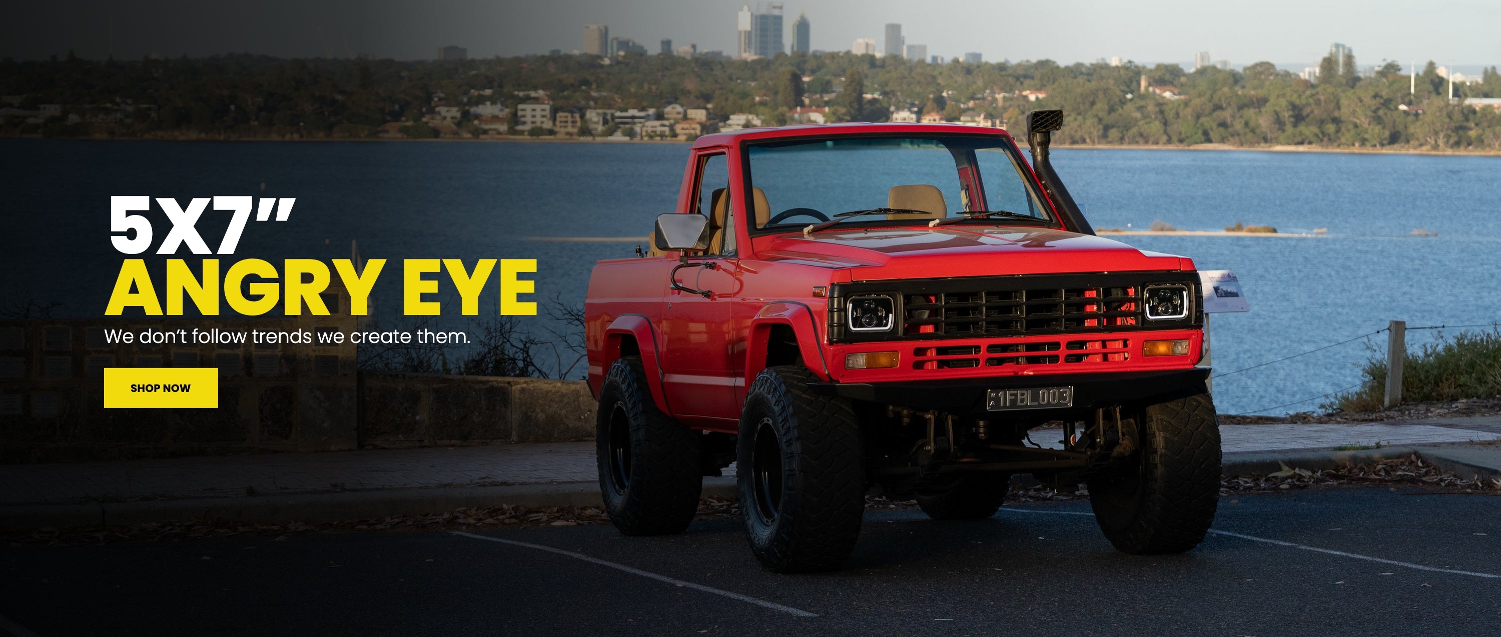 5x7 Angry Eye LED headlights on red lifted ute, Perth skyline