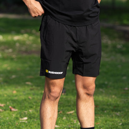 Bushdoof Staple Shorts in black, front view with logo on lower leg