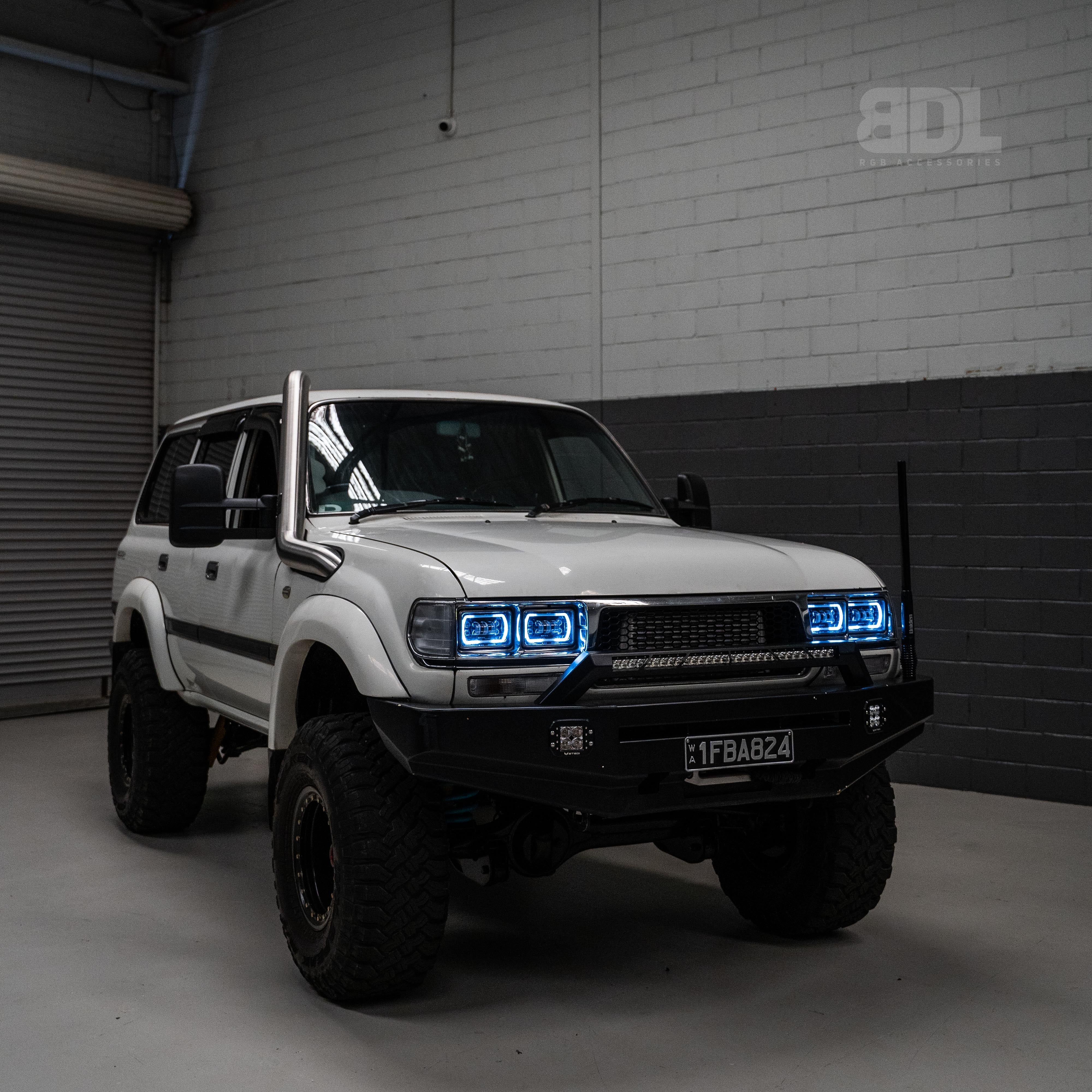 image of a while land cruiser fitted with 80 series led headlights from Bushdoof Lighting